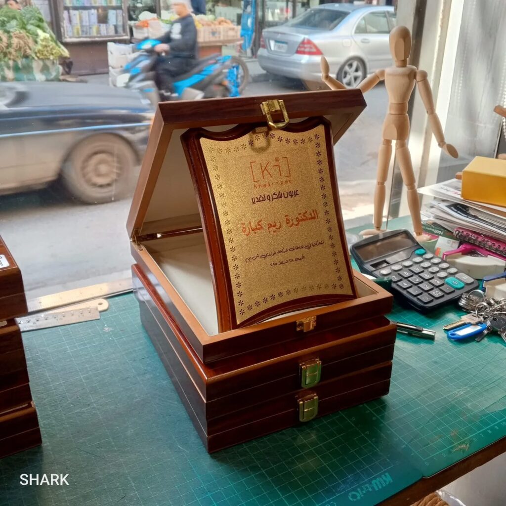 Arabic presentation award displayed in an open wooden case.