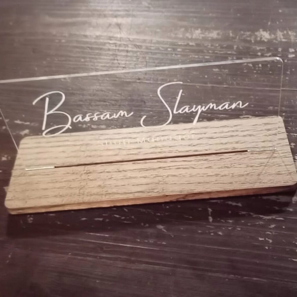 Clear Bassam Slayman desk nameplate set into a wooden base.