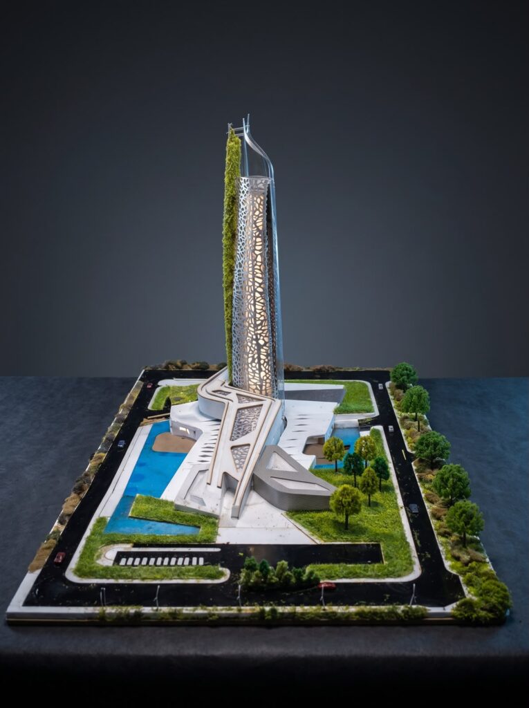 Illuminated high-rise architectural scale model with landscaped site