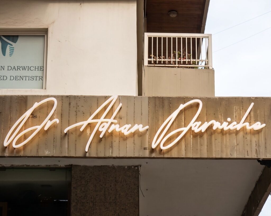 White signature-style dimensional lettering on a clinic facade.