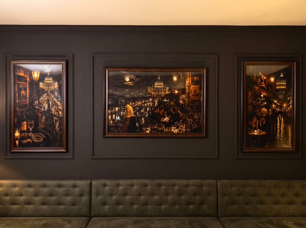 Three framed cityscape art prints above a seating area.