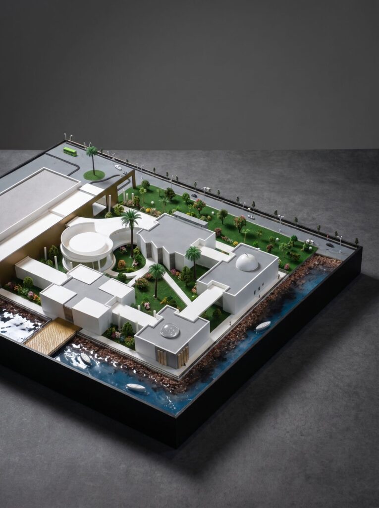 Elevated view of a waterfront villa scale model and surrounding landscape.